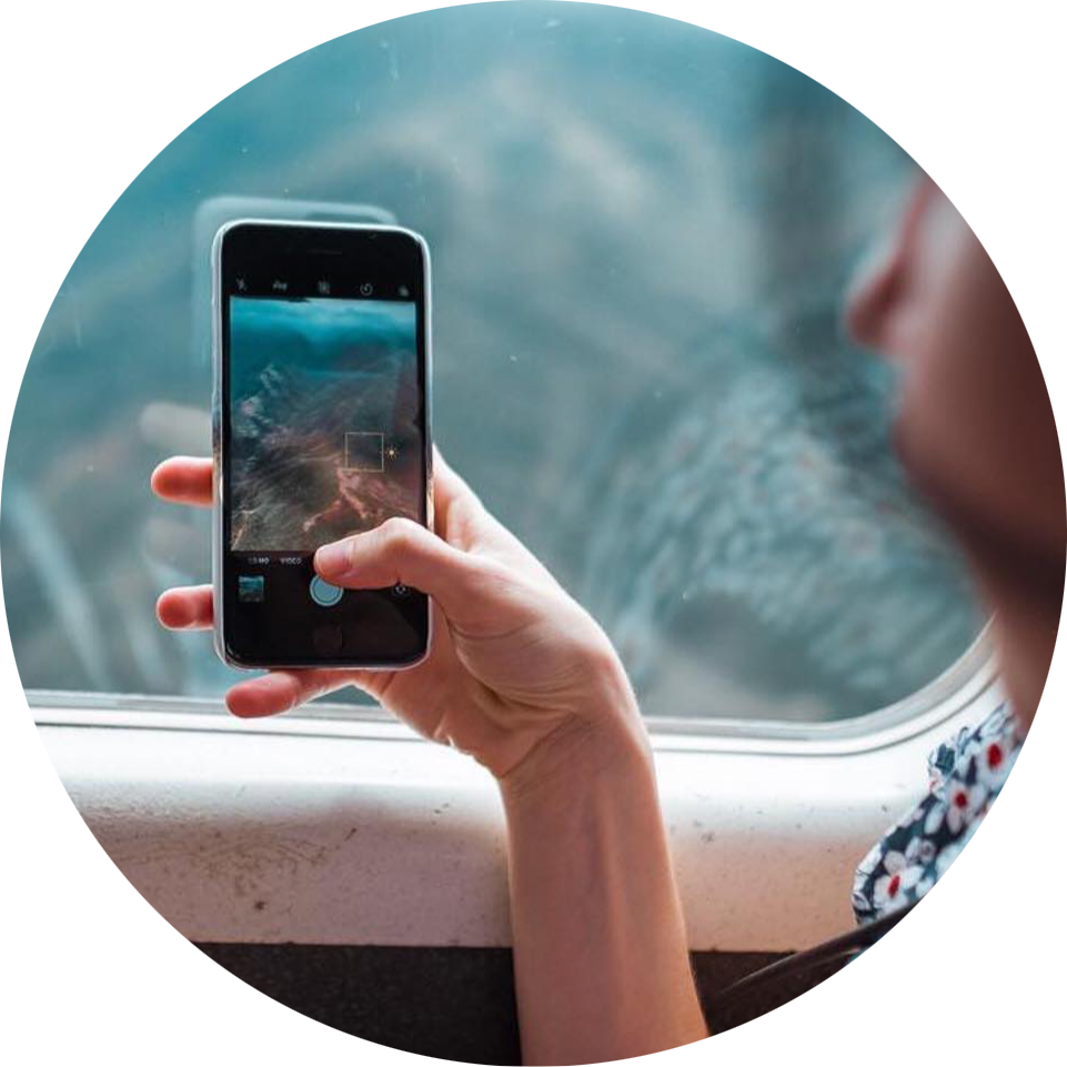 a man holding a camera in front of a mirror posing for the camera